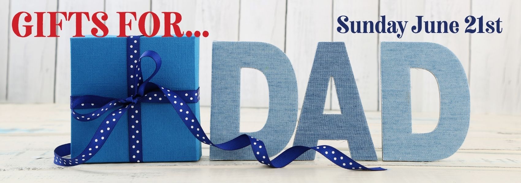 Blue gift box with a ribbon and 'DAD' letters on a wooden background with text 'Gifts for... Sunday June 21st'.